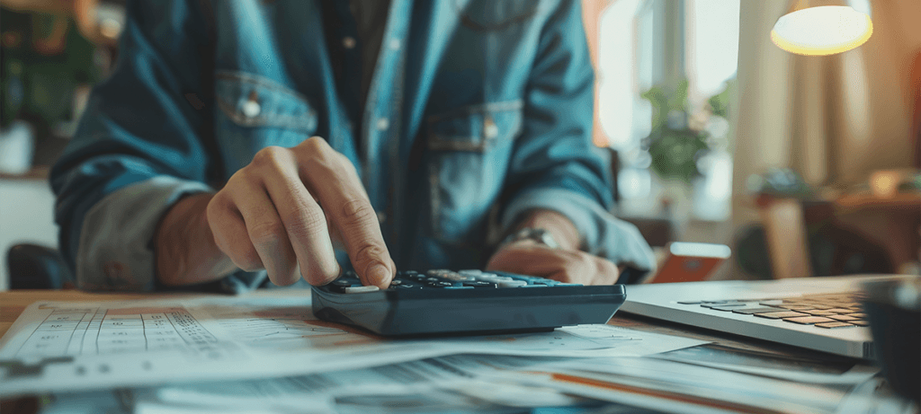 person using financial calculator planning their savings investments jpg